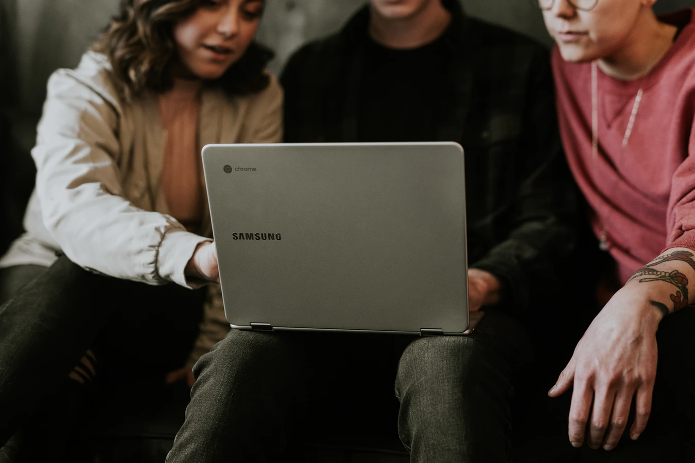People collaborating around laptop